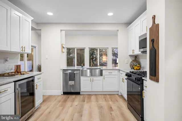 a kitchen with a sink cabinets and stainless steel appliances