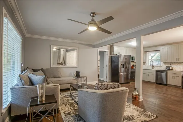 a living room with stainless steel appliances kitchen island granite countertop furniture and a kitchen view