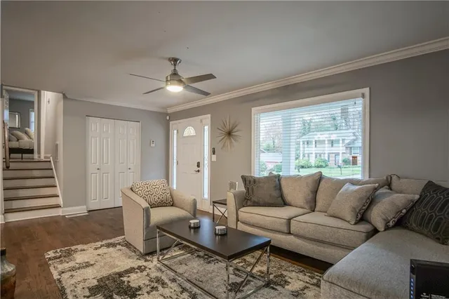 a living room with furniture and a large window