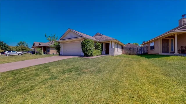 a front view of house with yard and green space