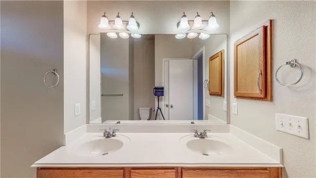 a bathroom with a sink double vanity and a mirror