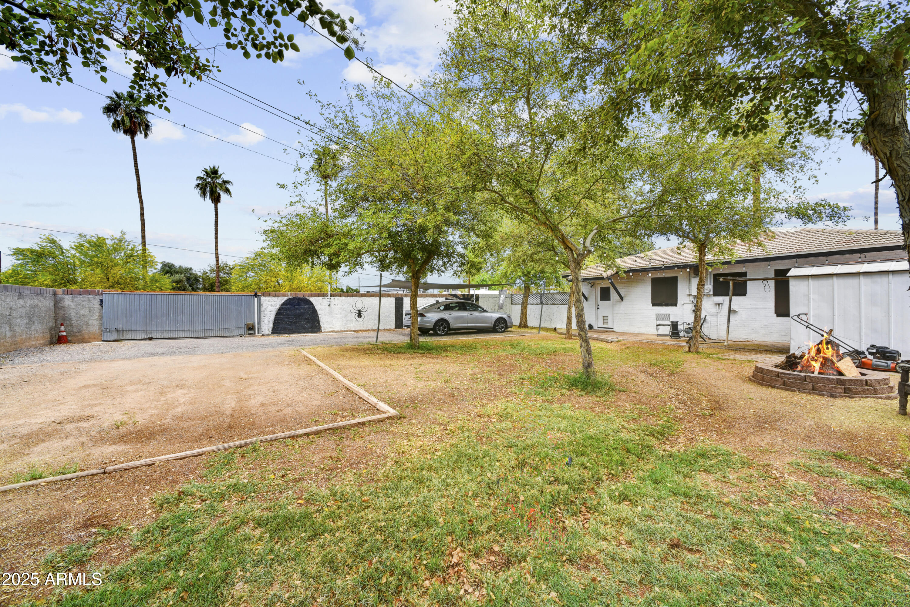 2045 West Orange Drive Phoenix, AZ 85015 - Photo 15 of 20 a view of a yard with a house and a large tree