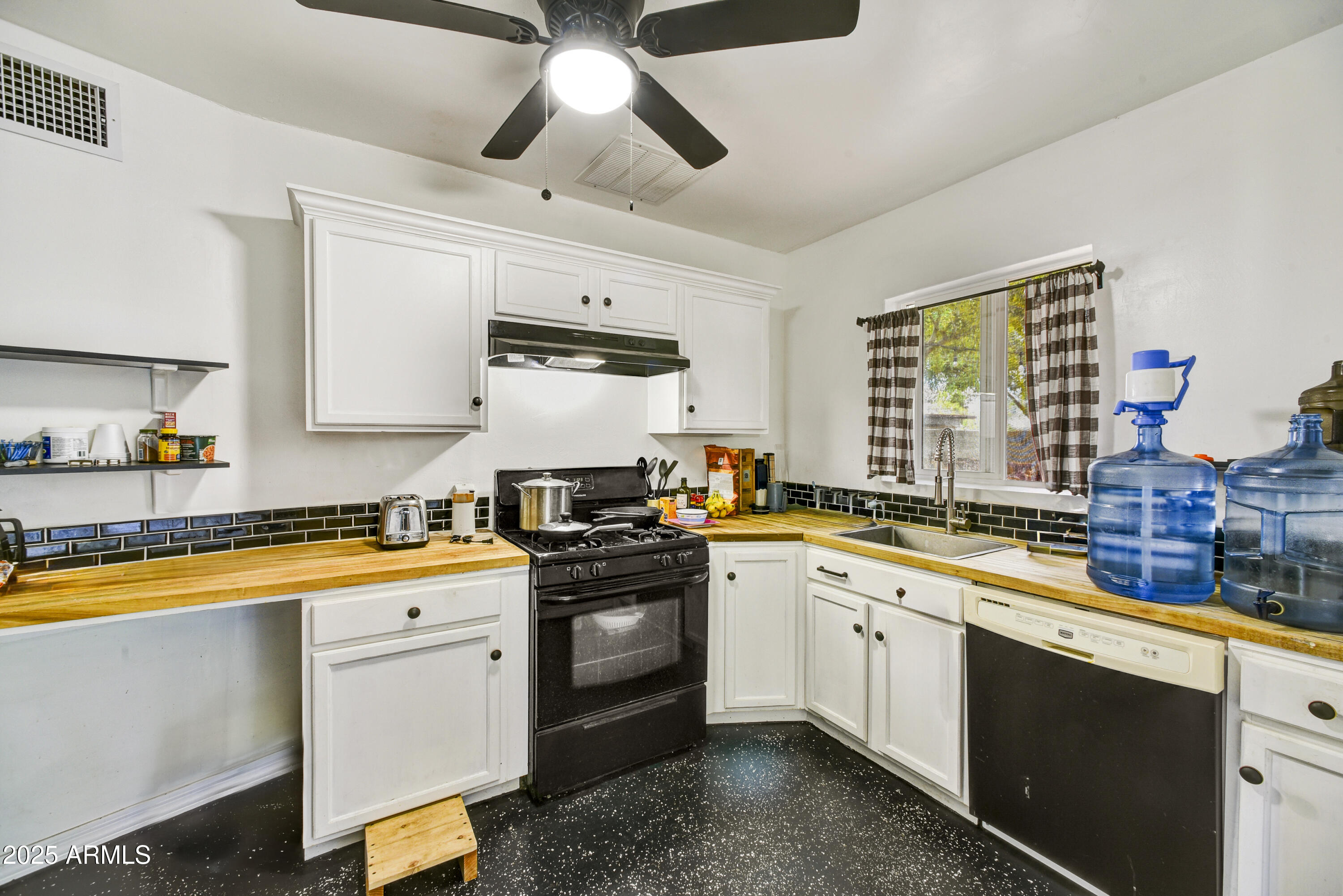 2045 West Orange Drive Phoenix, AZ 85015 - Photo 6 of 20 a kitchen with stainless steel appliances a sink a stove and cabinets