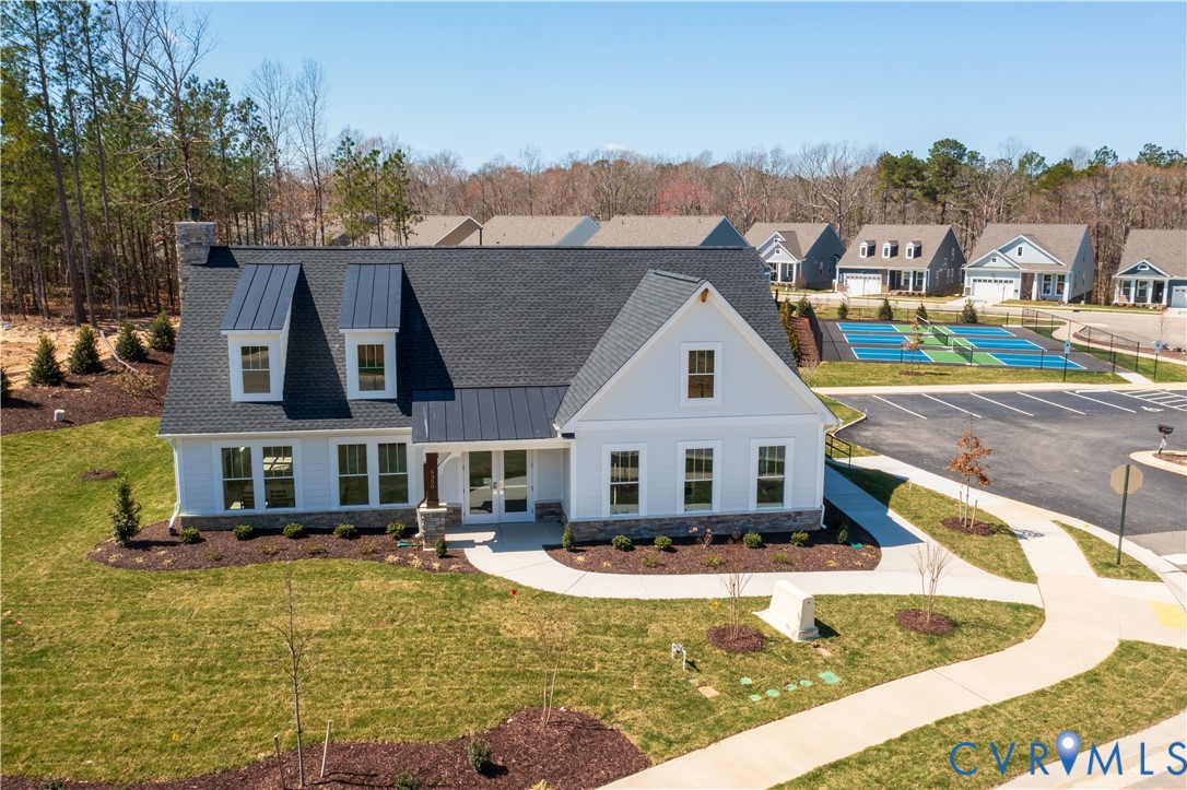 0 Canoe Pointe Loop, Unit 992 Moseley, VA 23120 - Photo 19 of 20 a view of a house with pool and trees in the background