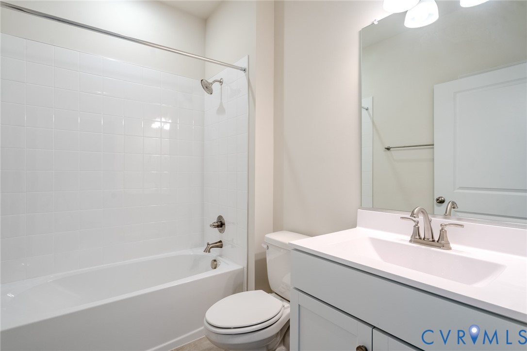 0 Canoe Pointe Loop, Unit 992 Moseley, VA 23120 - Photo 8 of 20 a bathroom with a bathtub shower sink vanity mirror and toilet