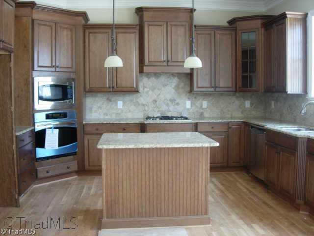 505 Starfire Court Oak Ridge, NC 27310 - Photo 2 of 4 Other. Kitchen features glazed cherry cabinets, granite counter tops, stainless appliances and backsplash