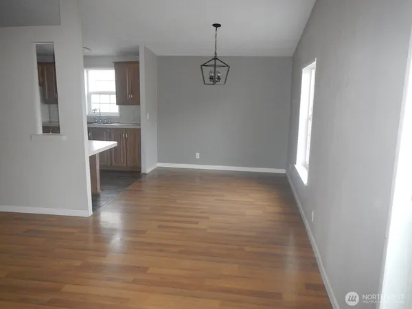 a view of a room with wooden floor and window