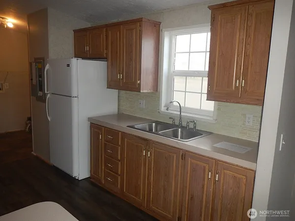 a kitchen with stainless steel appliances granite countertop a refrigerator sink and cabinets