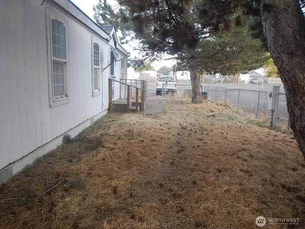 a view of a yard covered with snow in front of house