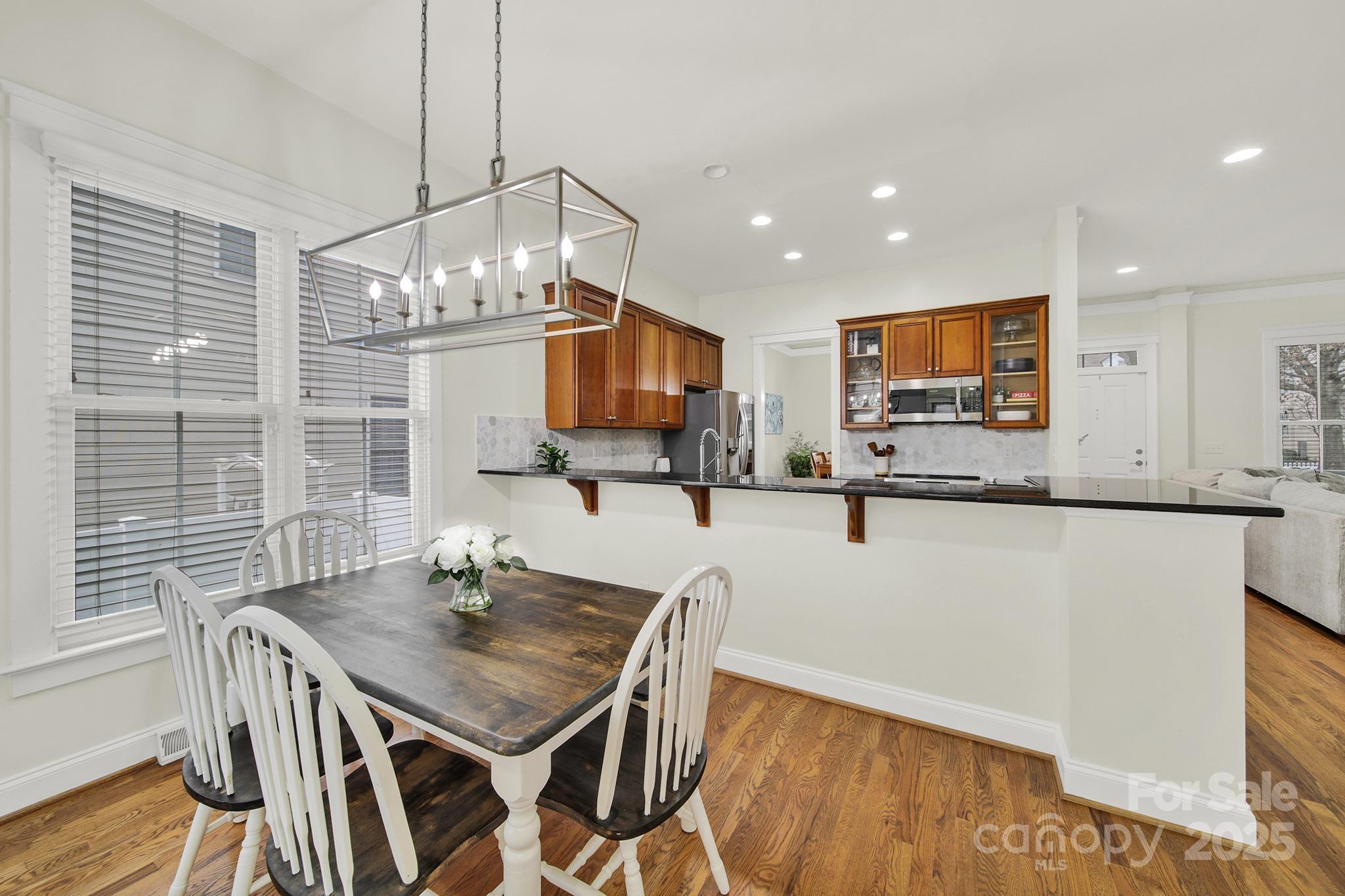 431 Third Baxter Street Fort Mill, SC 29708 - Photo 12 of 39 a kitchen with granite countertop kitchen island stainless steel appliances a table and chairs in it