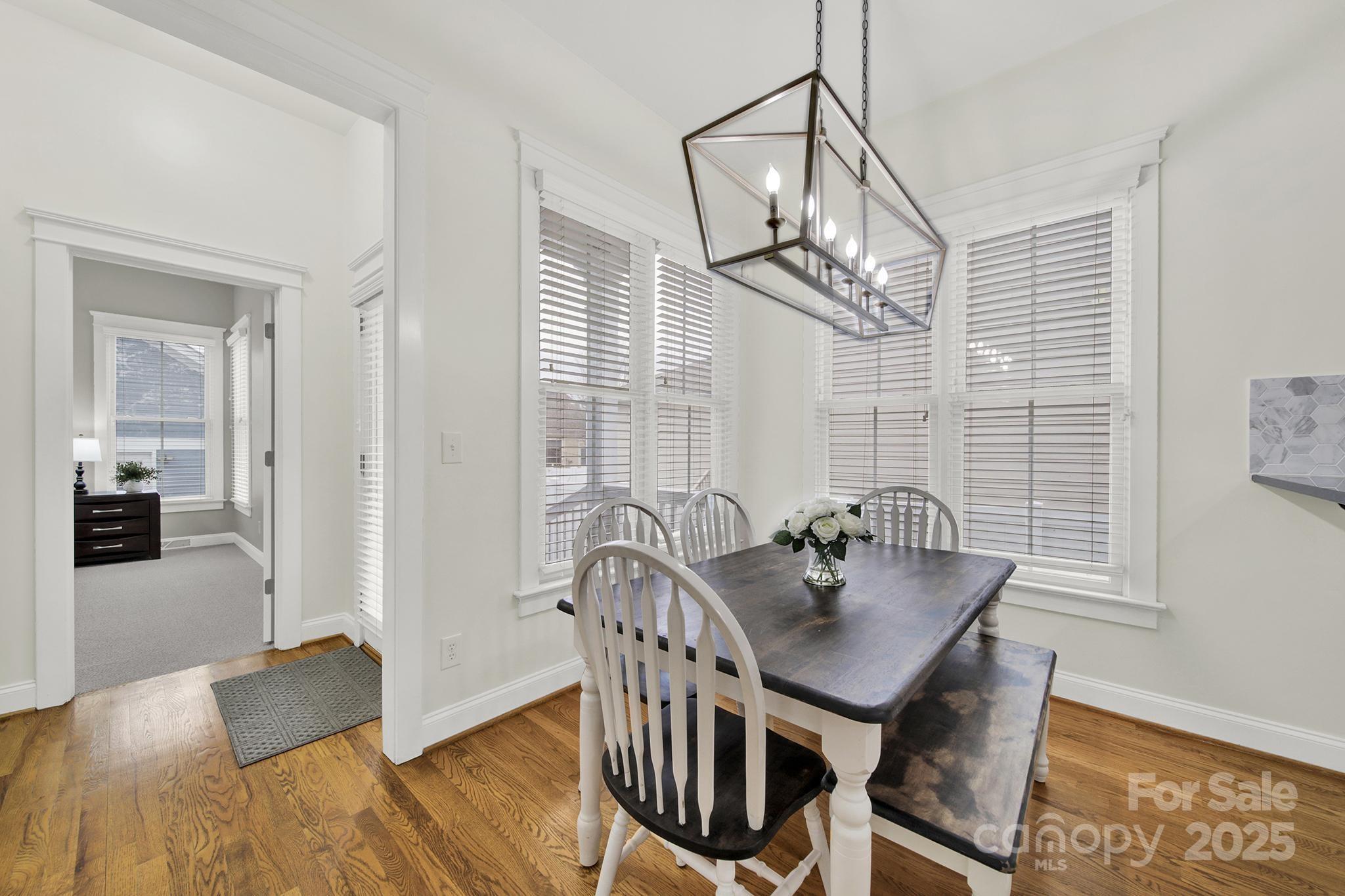 431 Third Baxter Street Fort Mill, SC 29708 - Photo 13 of 39 a view of a dining room with furniture and wooden floor