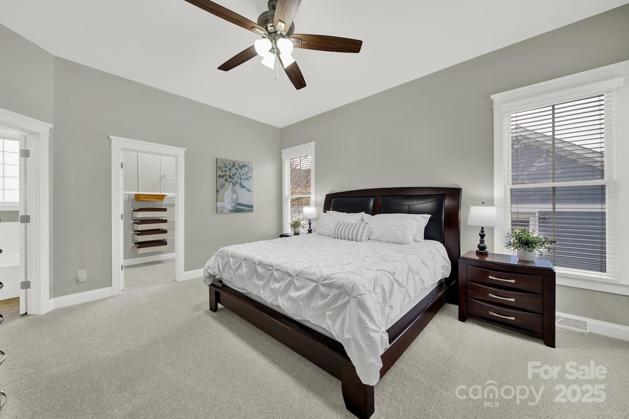 431 Third Baxter Street Fort Mill, SC 29708 - Photo 15 of 39 a spacious bedroom with a bed and a chandelier