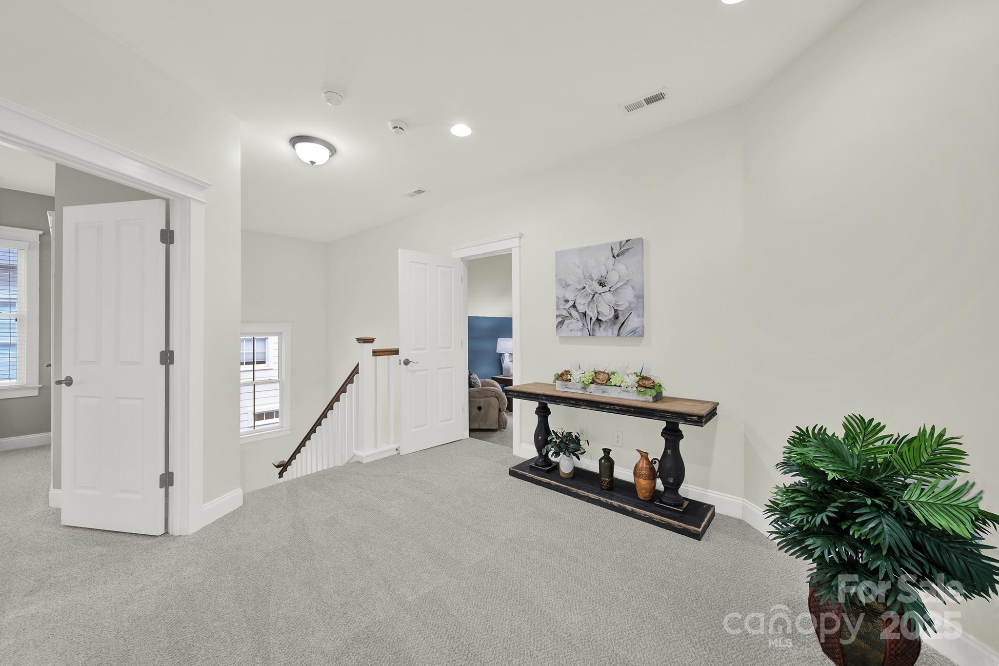 431 Third Baxter Street Fort Mill, SC 29708 - Photo 21 of 39 a view of a hallway with paintings on the wall