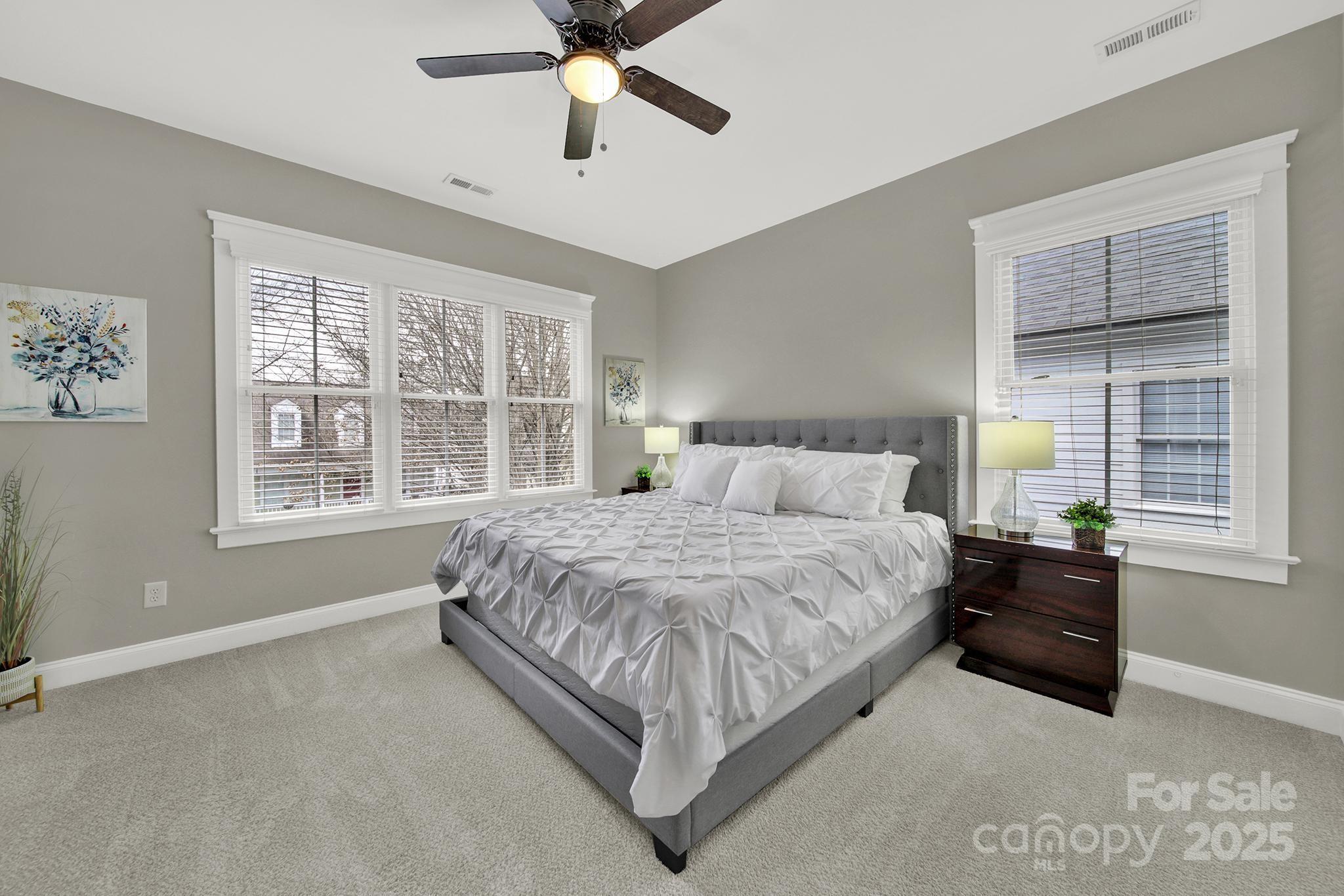 431 Third Baxter Street Fort Mill, SC 29708 - Photo 25 of 39 a spacious bedroom with a large bed and windows