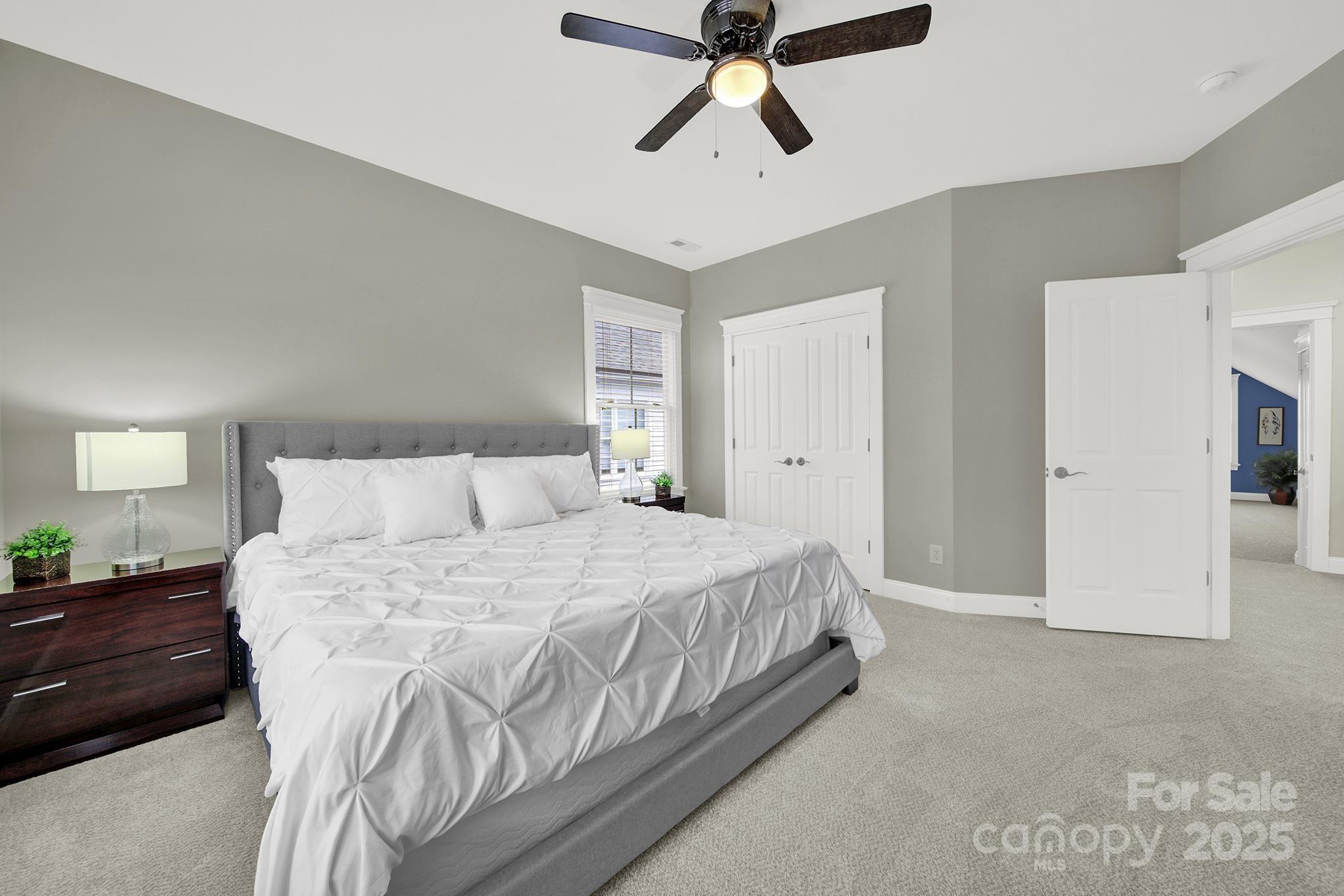 431 Third Baxter Street Fort Mill, SC 29708 - Photo 26 of 39 a bedroom with a bed and a chandelier