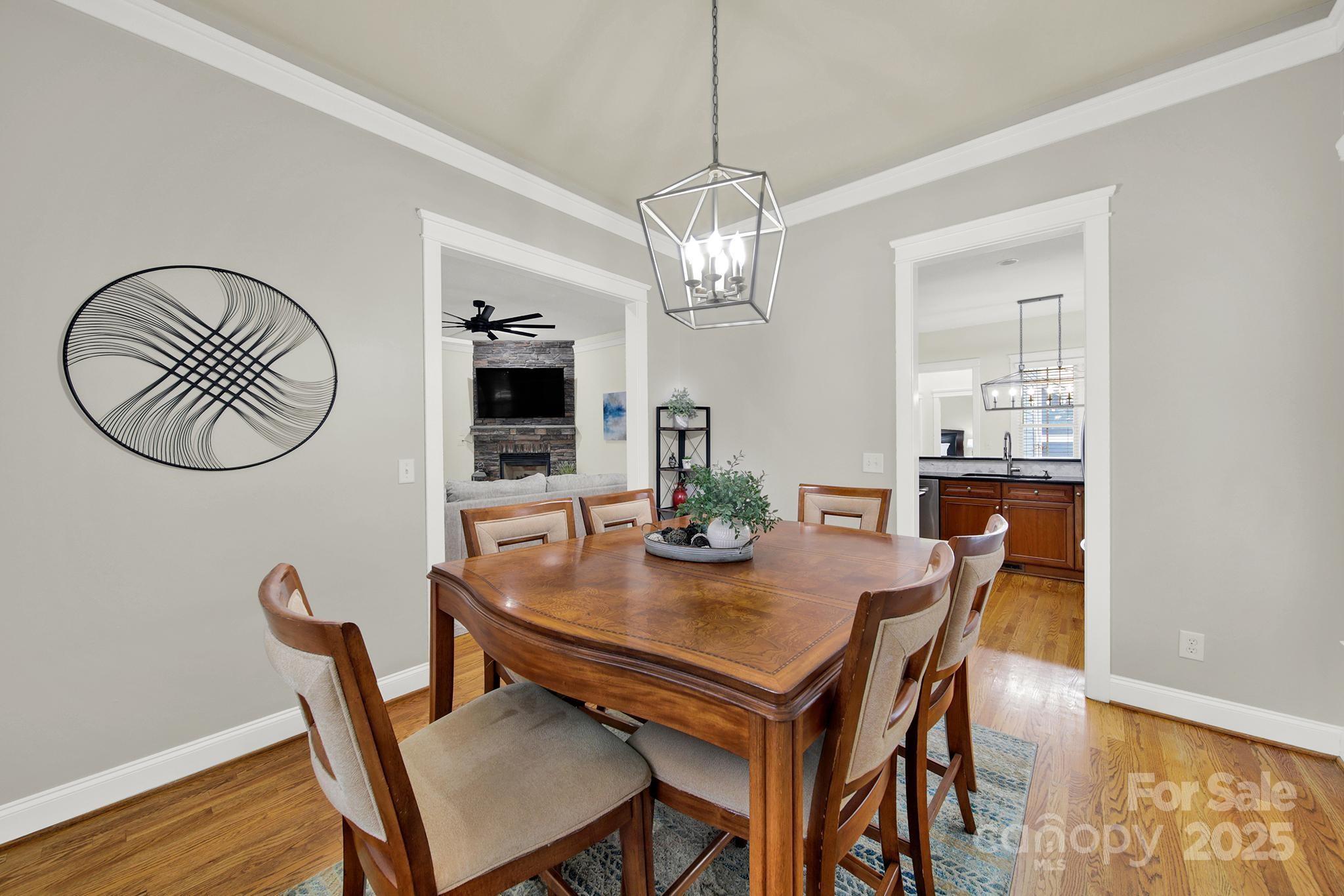 431 Third Baxter Street Fort Mill, SC 29708 - Photo 4 of 39 a view of a dining room with furniture a chandelier and wooden floor