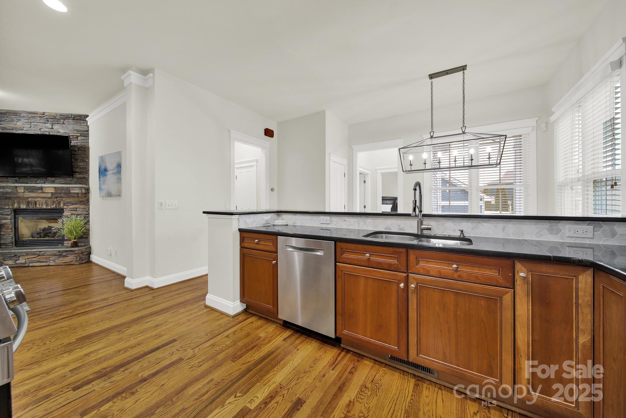 431 Third Baxter Street Fort Mill, SC 29708 - Photo 10 of 39 a kitchen with stainless steel appliances granite countertop a sink a stove a microwave and wooden floors