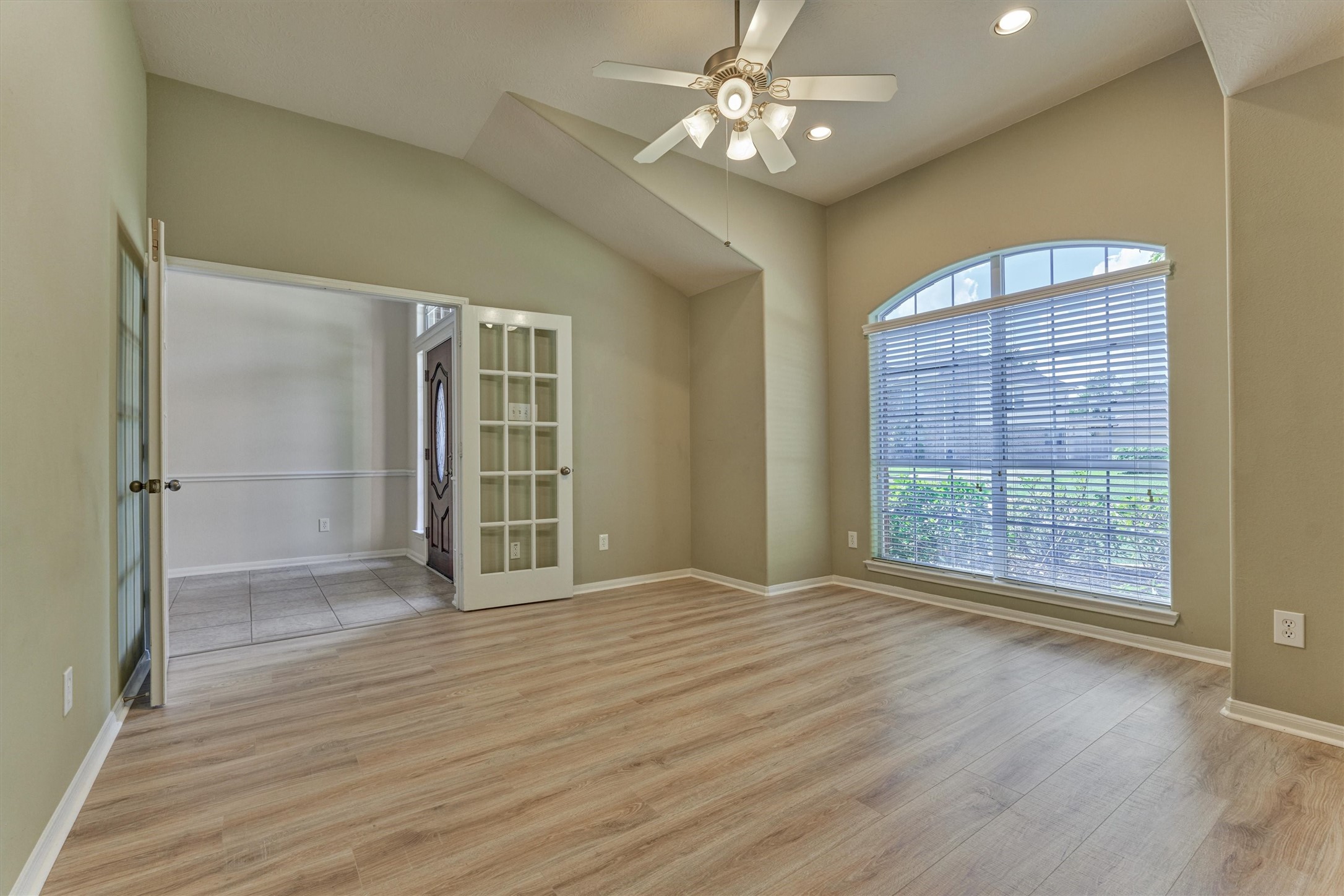 24910 Corbin Gate Drive Spring, TX 77389 - Photo 11 of 49 a view of an empty room with wooden floor and a window