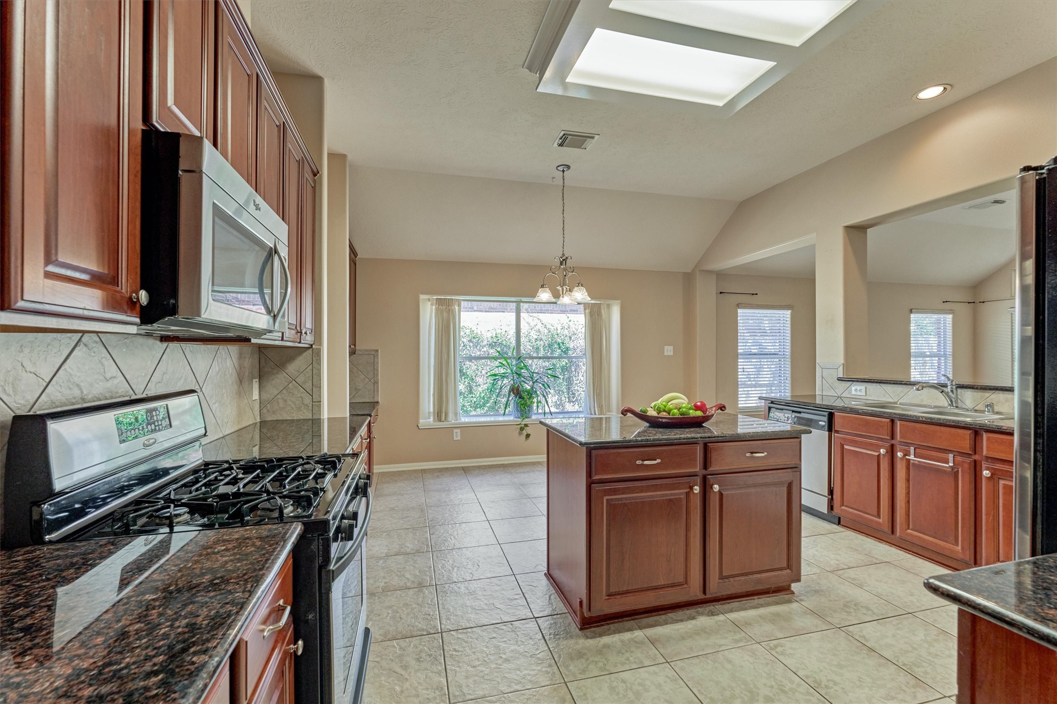 24910 Corbin Gate Drive Spring, TX 77389 - Photo 14 of 49 a kitchen with granite countertop cabinets and window