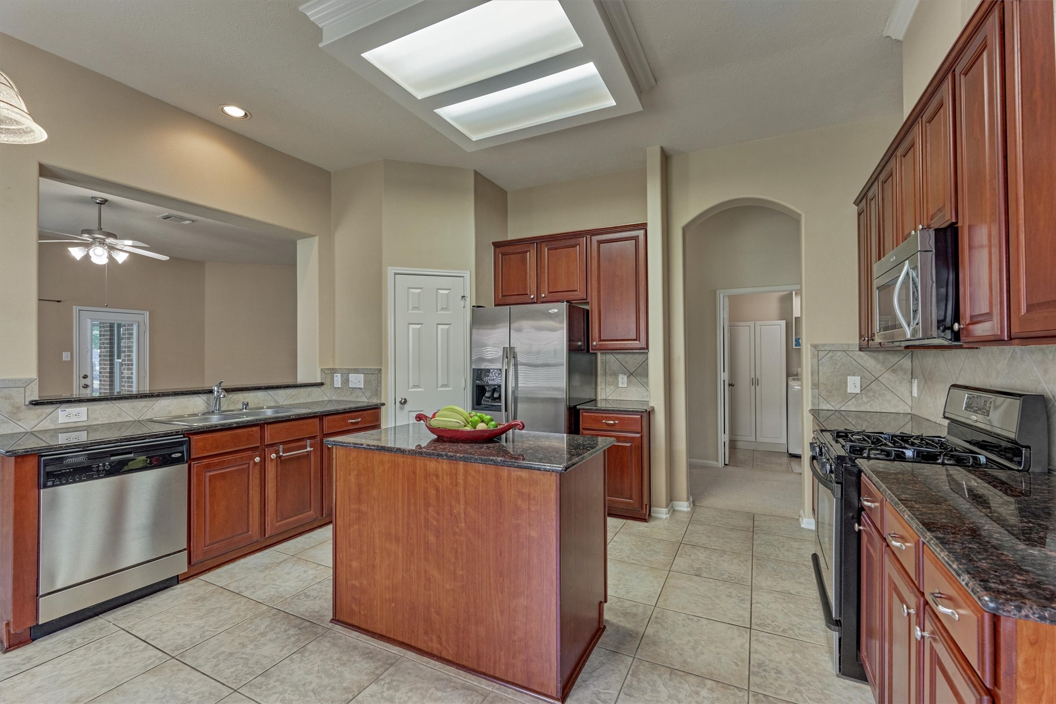 24910 Corbin Gate Drive Spring, TX 77389 - Photo 16 of 49 a kitchen with stainless steel appliances granite countertop a sink stove and refrigerator