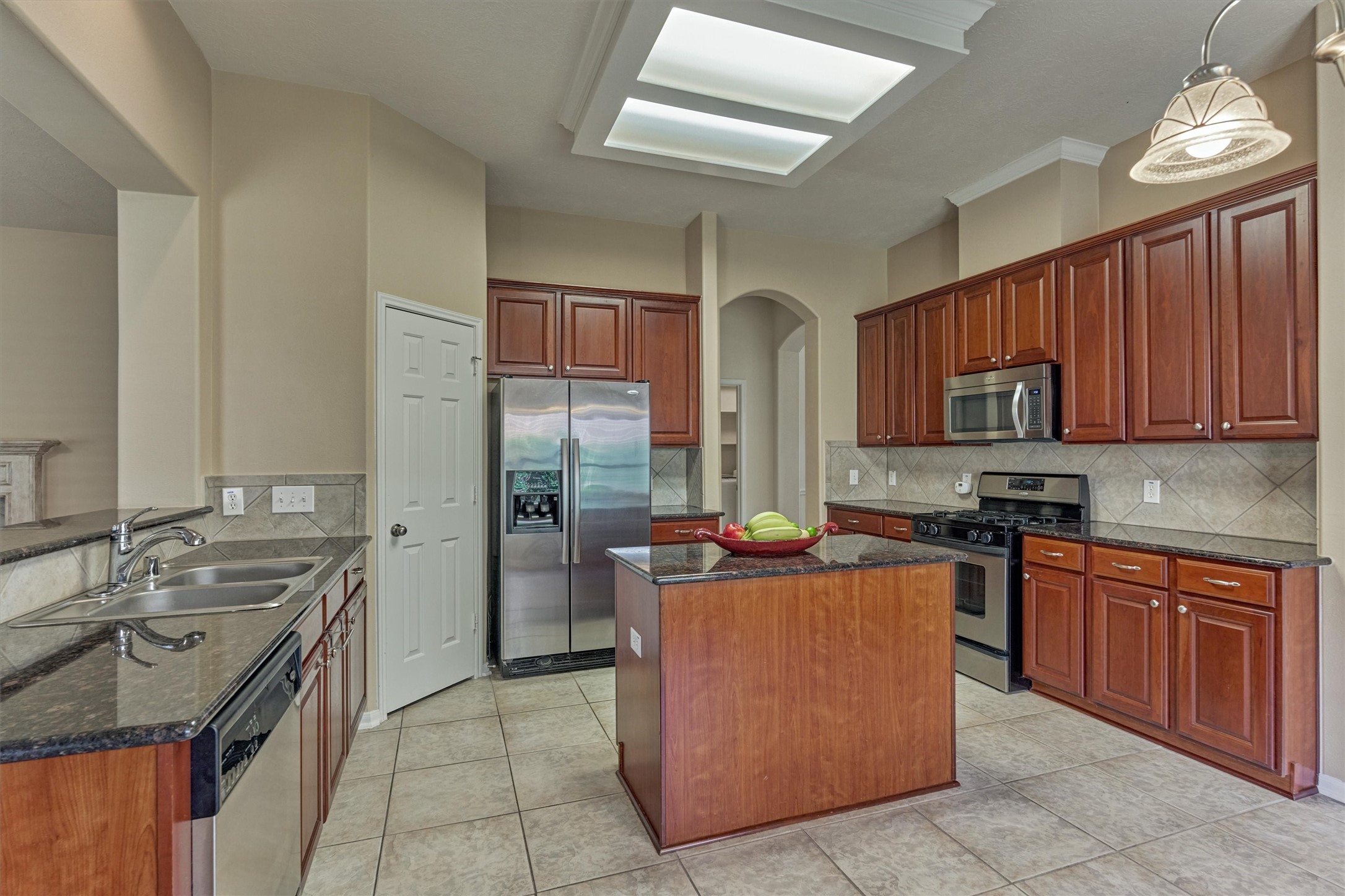 24910 Corbin Gate Drive Spring, TX 77389 - Photo 18 of 49 a kitchen with stainless steel appliances granite countertop a stove refrigerator and a sink