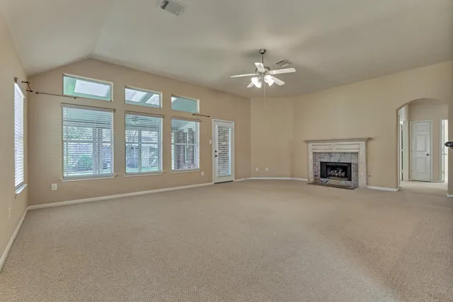 a view of an empty room with a fireplace