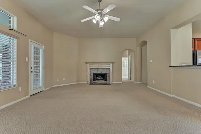 a view of a room with chandelier fan and windows