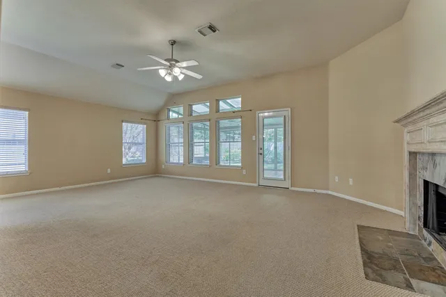 a view of an empty room with a fireplace