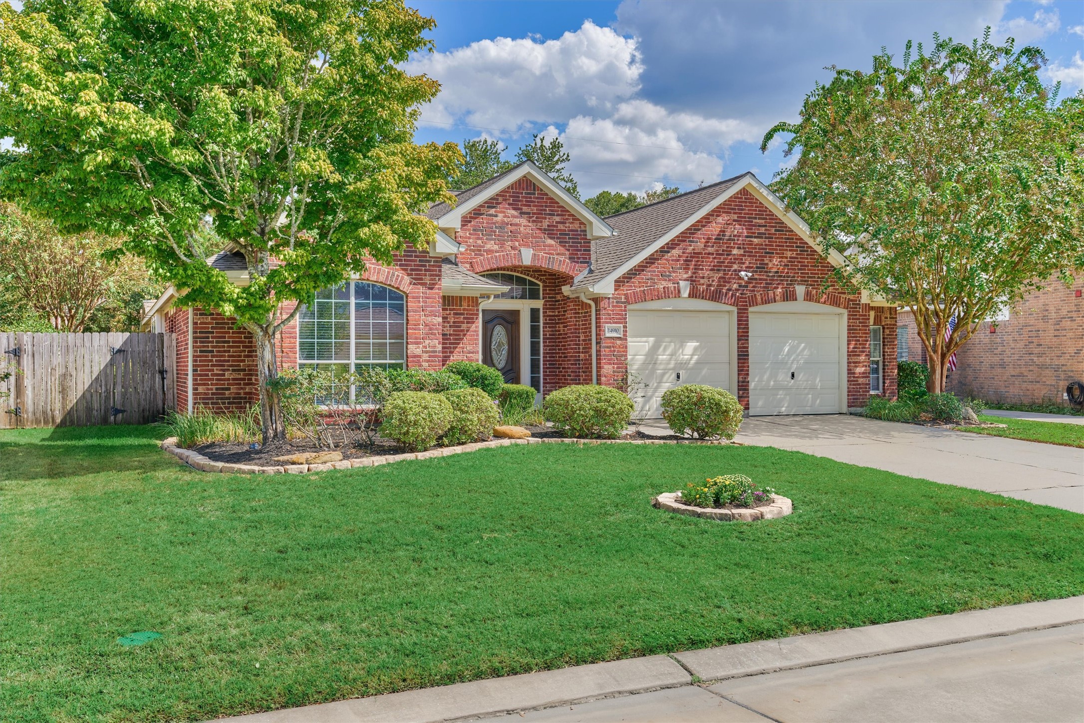 24910 Corbin Gate Drive Spring, TX 77389 - Photo 3 of 49 a front view of a house with a yard and trees