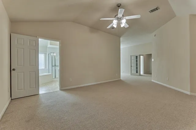 a view of a room with a ceiling fan and a chandelier fan