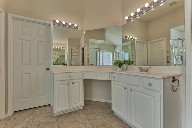 a bathroom with a double vanity sink and a mirror