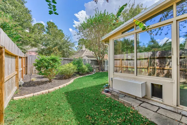 a view of a house with backyard and a tree