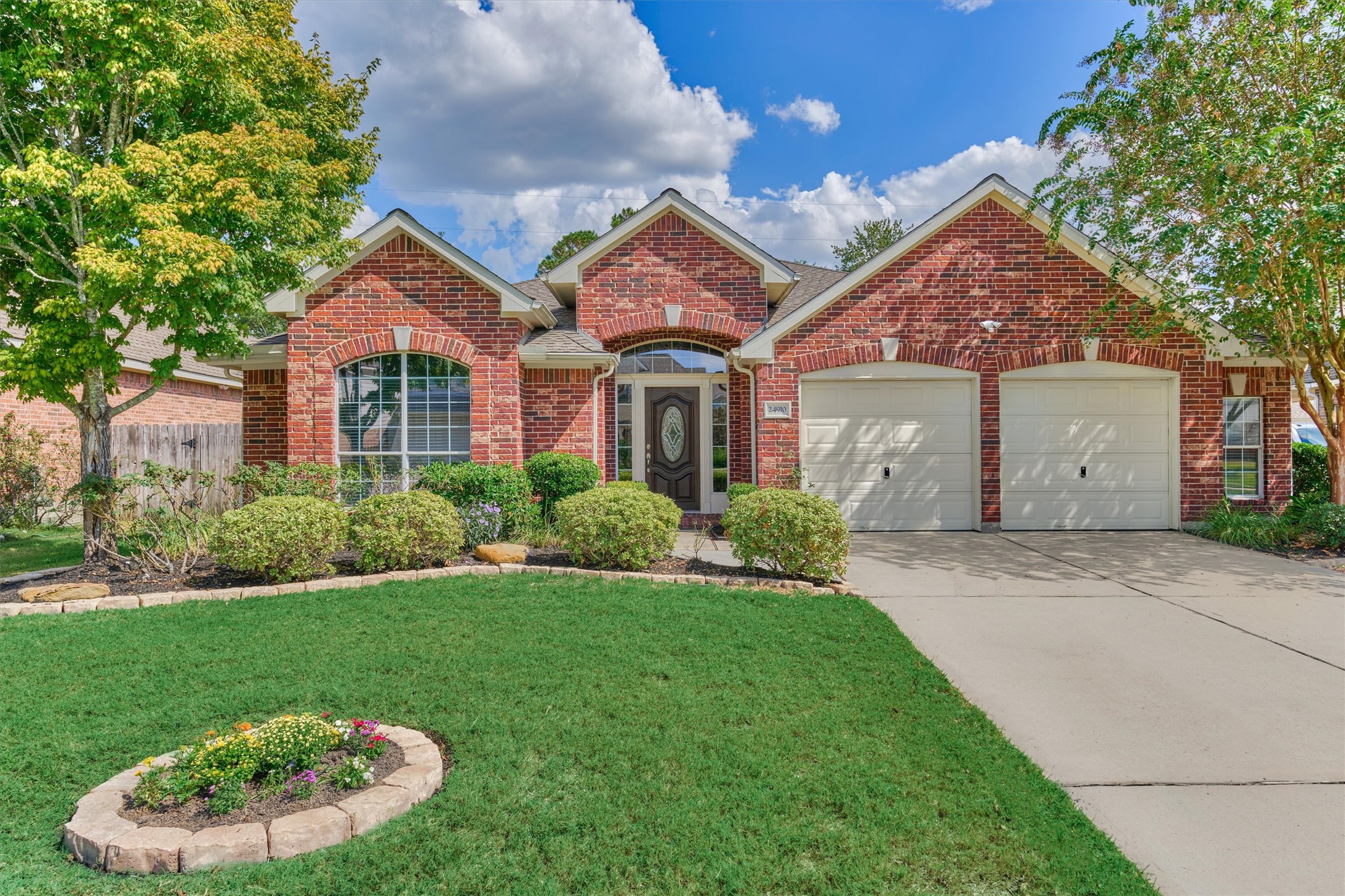 24910 Corbin Gate Drive Spring, TX 77389 - Photo 4 of 49 a view of a white house next to a yard and a large tree