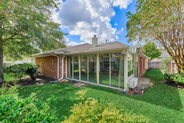 a view of a house with a backyard