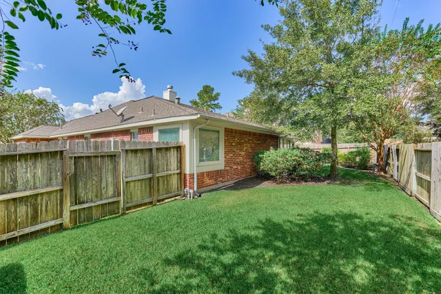 a view of a house with a backyard