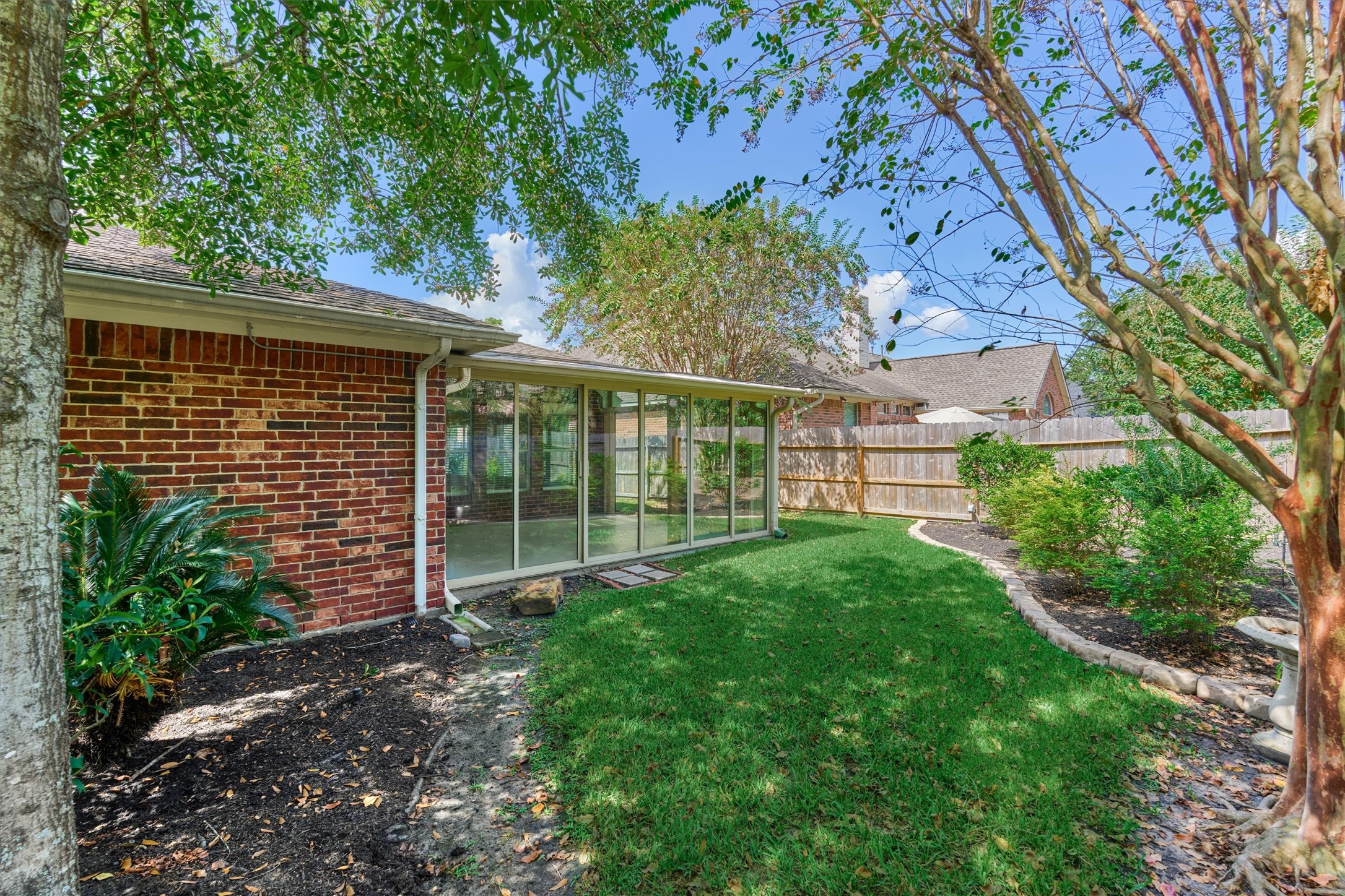 24910 Corbin Gate Drive Spring, TX 77389 - Photo 45 of 49 a view of a backyard with plants and large tree