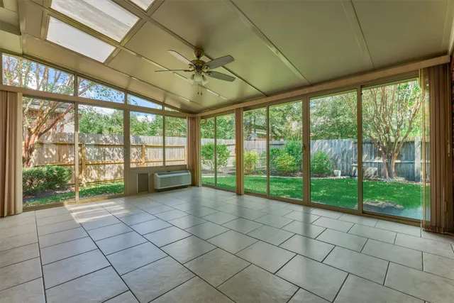 a view of room with window and ceiling fan