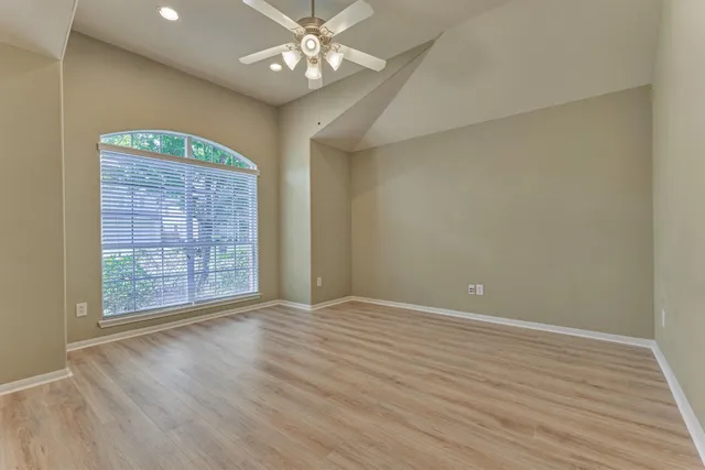 wooden floor in an empty room with a window