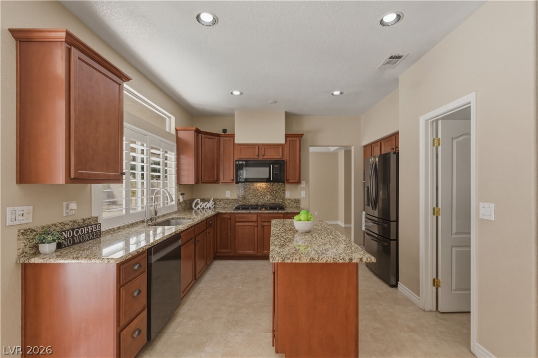 29 Olive Tree Henderson, NV 89074 - Photo 14 of 60 This functional kitchen features ample workspace, modern appliances, and a convenient layout for everyday living.