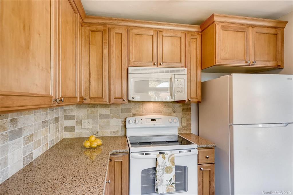 4214 Randolph Road Charlotte, NC 28211 - Photo 7 of 17 a kitchen with a stove a refrigerator and cabinets