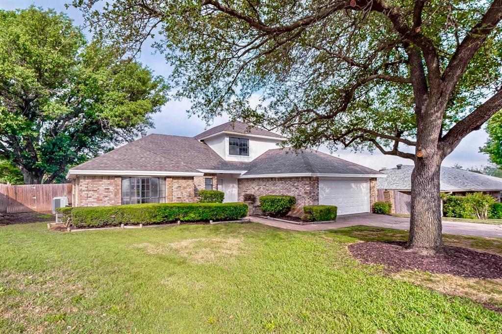 3965 Singleleaf Lane Fort Worth, TX 76133 - Photo 8 of 39 Traditional brick exterior with white trim, featuring a two-car garage