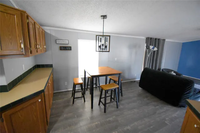 a living room with furniture and a dining table