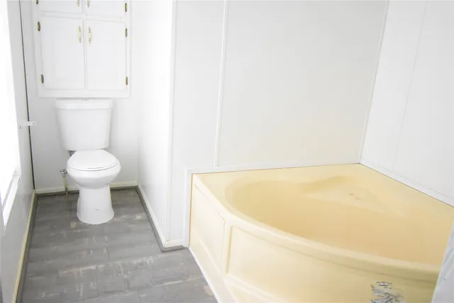 a bathroom with a bathtub and toilet