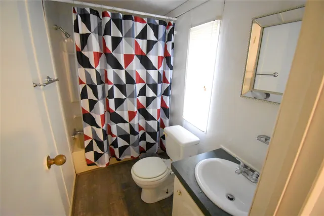 a bathroom with a sink toilet and shower