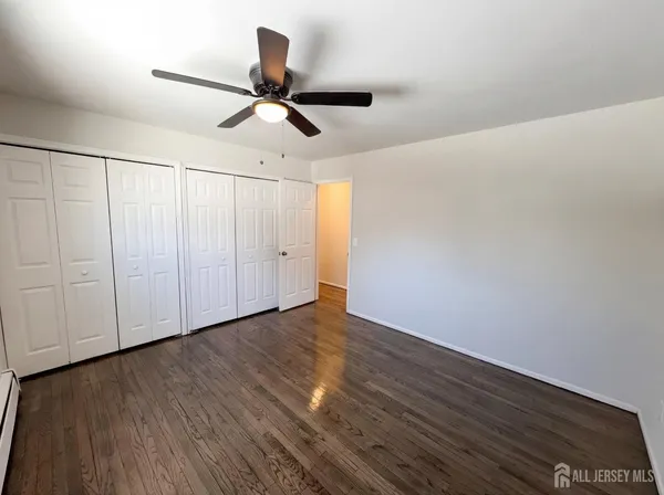 a view of room with wooden floor ceiling fan