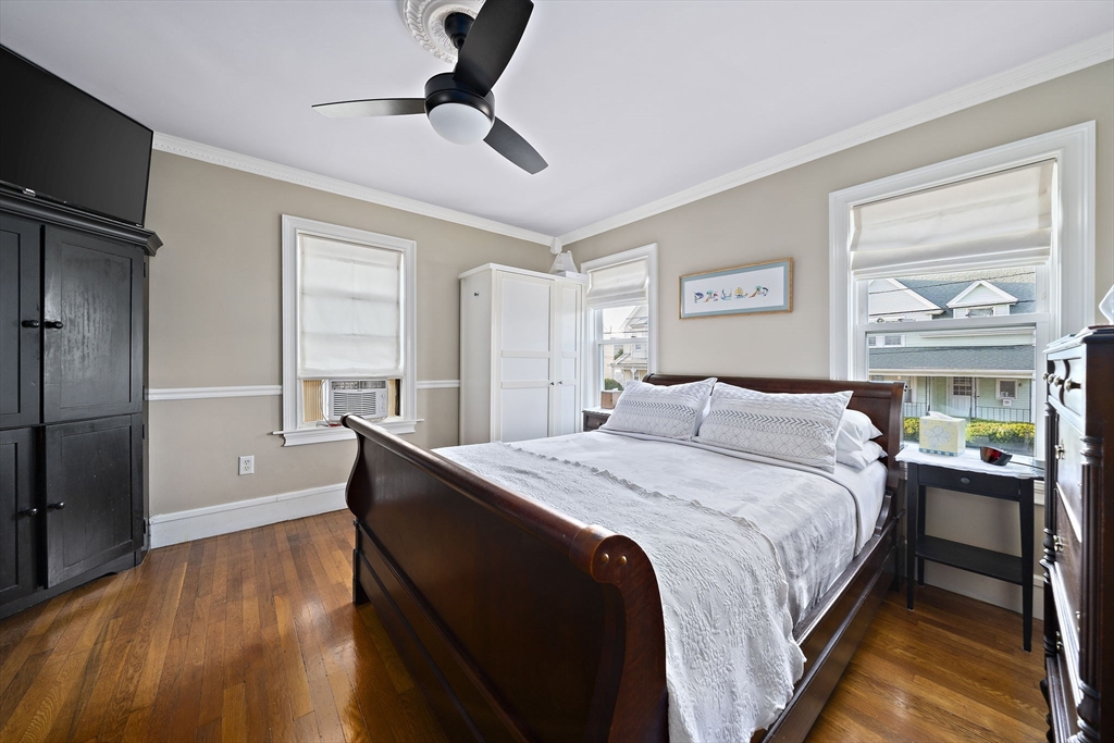 77 Botolph Street Quincy, MA 02171 - Photo 12 of 42 a bedroom with a bed and wooden floor