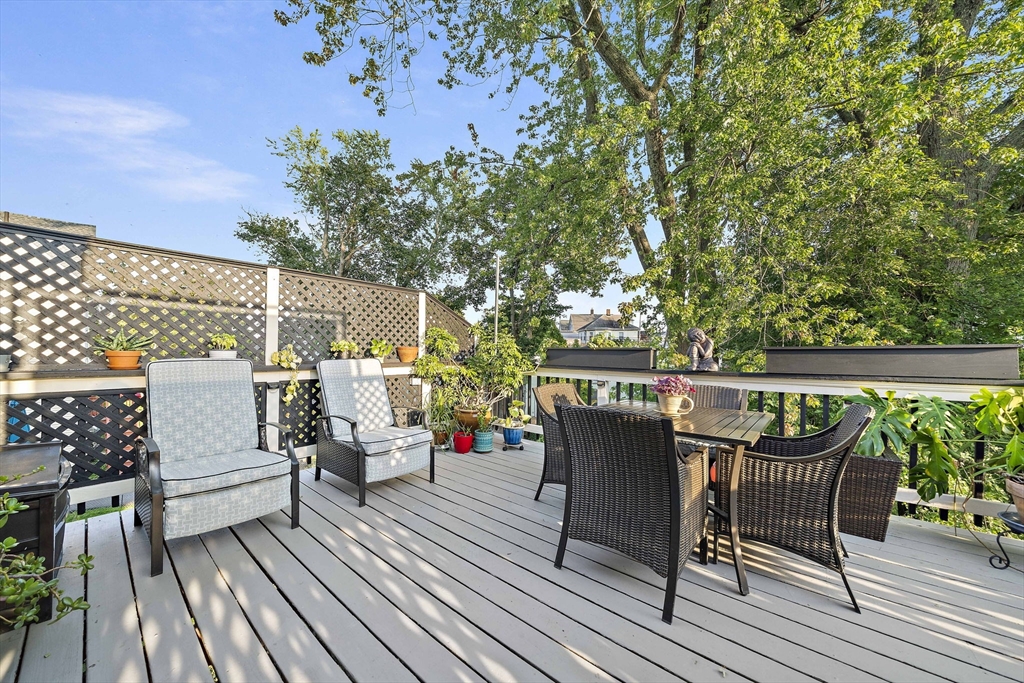 77 Botolph Street Quincy, MA 02171 - Photo 20 of 42 an outdoor sitting area with couch and wooden floor