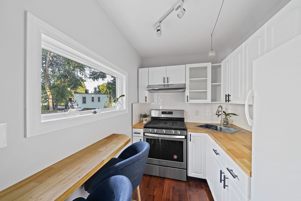 77 Botolph Street Quincy, MA 02171 - Photo 24 of 42 a kitchen with a stove a sink and a window