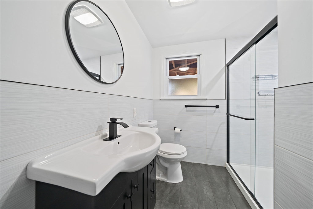 77 Botolph Street Quincy, MA 02171 - Photo 25 of 42 a bathroom with a toilet sink and a mirror