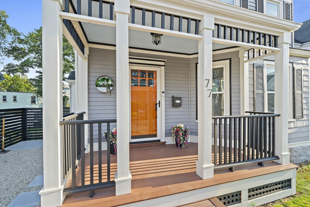 77 Botolph Street Quincy, MA 02171 - Photo 3 of 42 a view of a brick house with large windows and a white fence